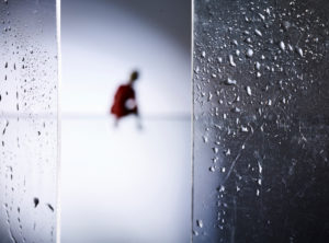Symbolic image social distancing, silhouette of a lonely person, glass panes with droplets Symbolic image social distancing, silhouette of a lonely person, glass panes with droplets